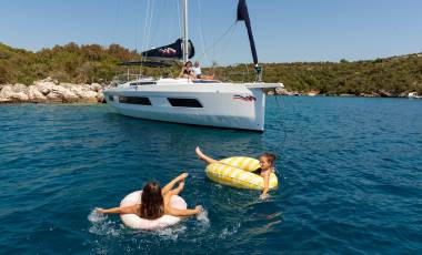 Guests enjoying the water in Croatia with monohull in the background
